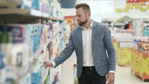 man choosing his shampoo and a convenience store 