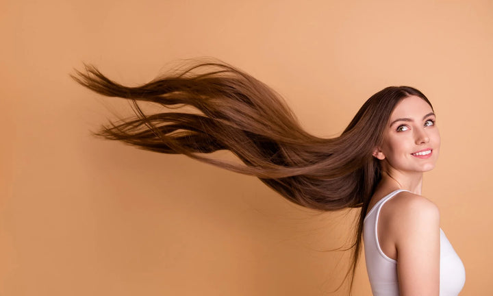 lady with long hair on an orange backdrop