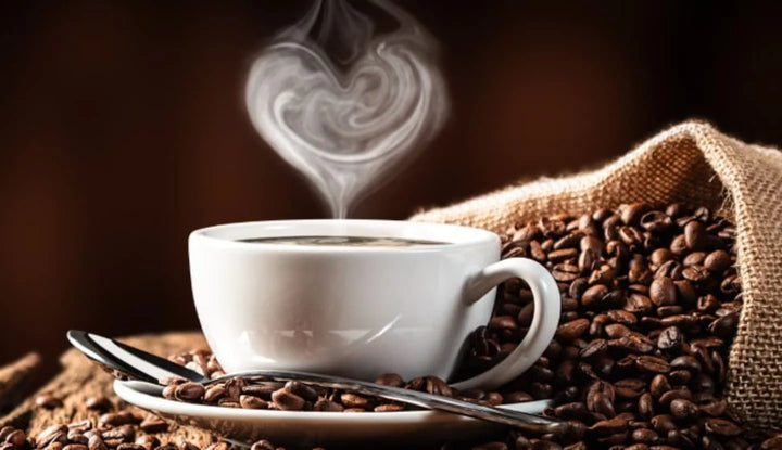 coffe in a whit ecoffee mug on a mountain of coffee beans