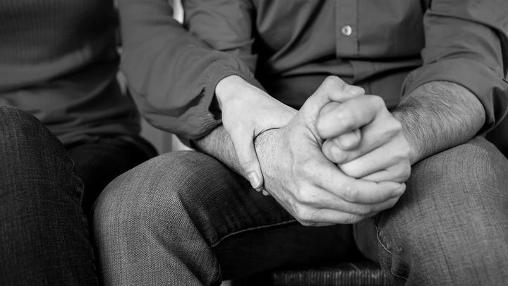 black and white image of couples holding hands