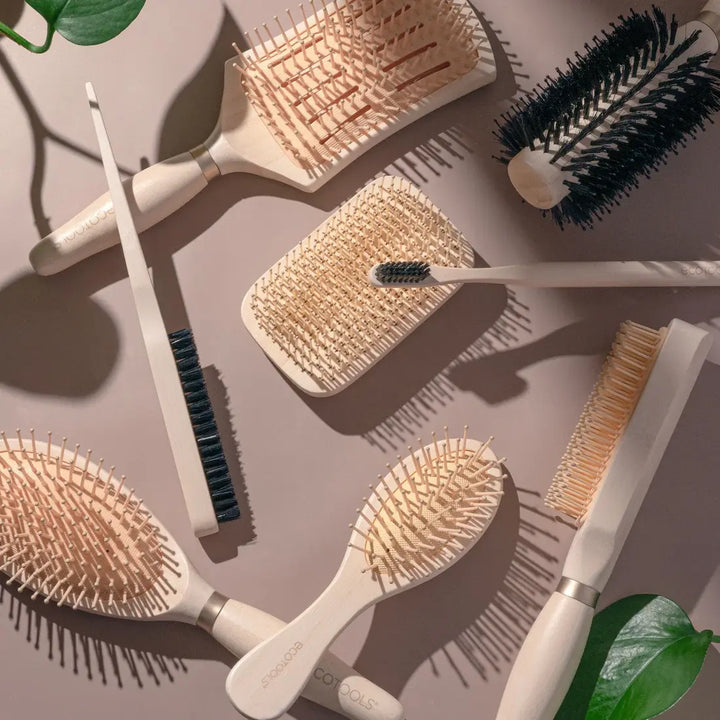 different hair brushes laid out on a table