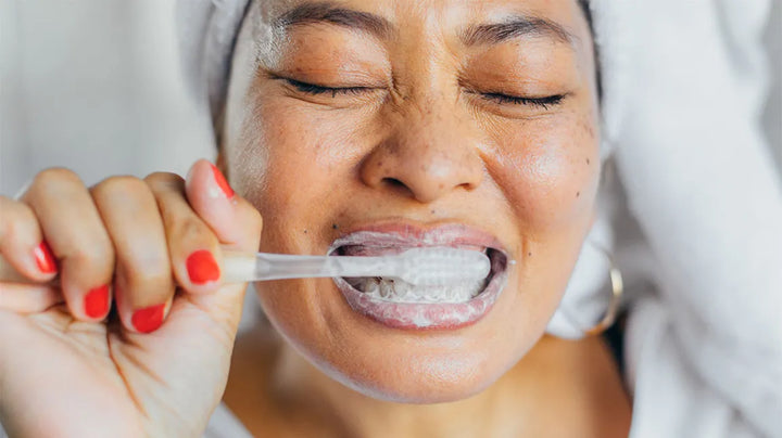 woman brushing her teeth