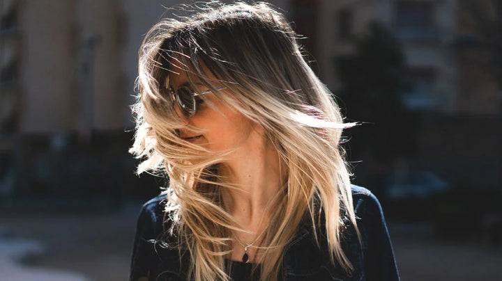 lady with blonde healthy hair in the wind