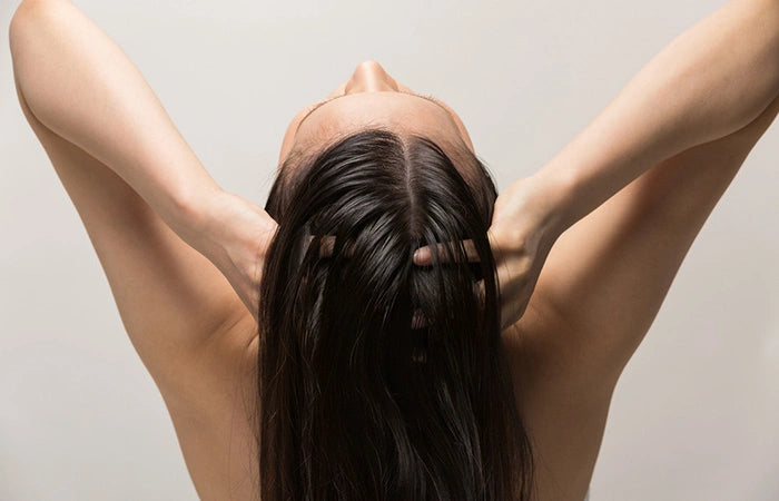 woman applying hair lotion