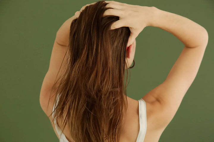 lady combing her fingers through her hair