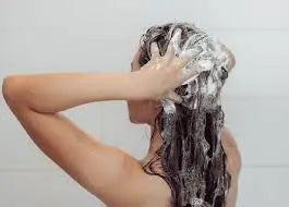 lady shampooing her hair