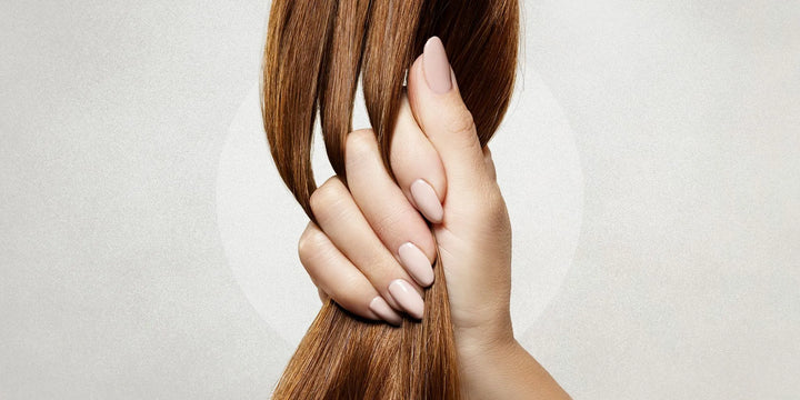 lady holding thick healthy hair close up on hand holding the hair