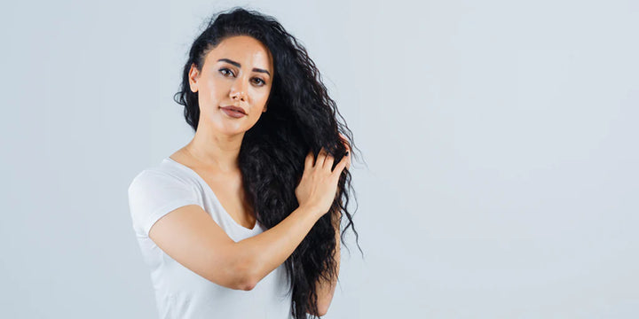 lady combing through her curly hair