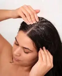 lady massaging product into her scalp