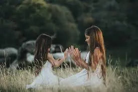 two girls playing in the grass