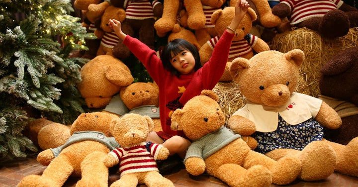 girl sitting in a pile of toys