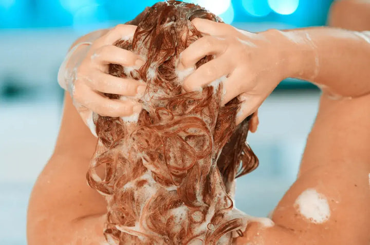 woman washing her hair in shower