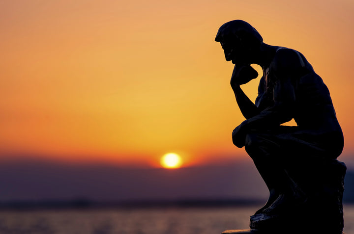 man thinking in sunset